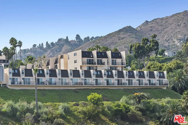 a view of a house with a garden and a yard