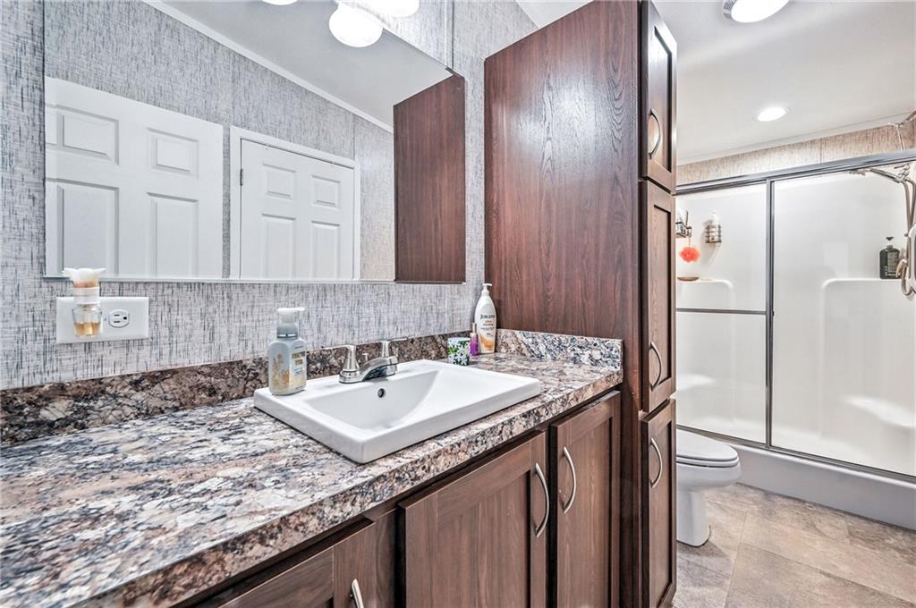 73 South Summit Road, Unit 503 Greenville, PA 16125 - Photo 17 of 36 a bathroom with a granite countertop sink and a mirror