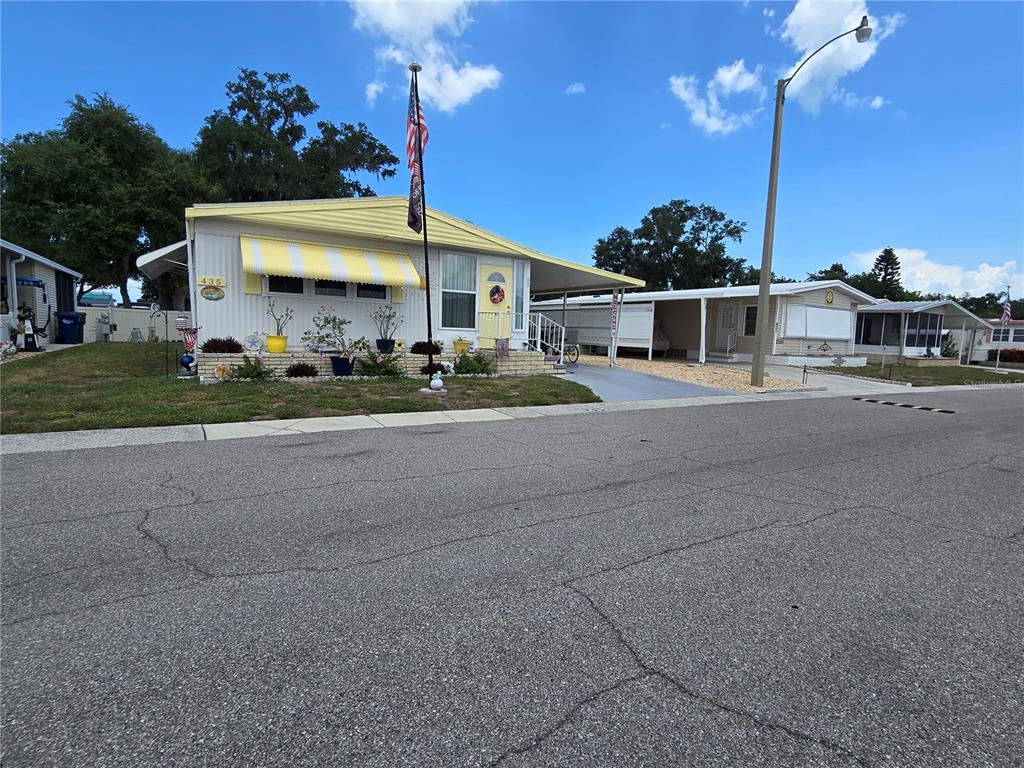 5619 Bayshore Road, Unit 435 Palmetto, FL 34221 - Photo 43 of 56 a front view of a house with a yard and outdoor seating