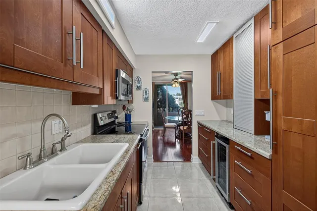 a kitchen with stainless steel appliances granite countertop a sink stove and cabinets
