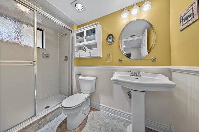 a bathroom with a toilet sink and mirror