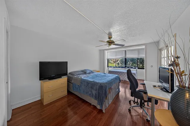 a living room with furniture flat screen tv and a window