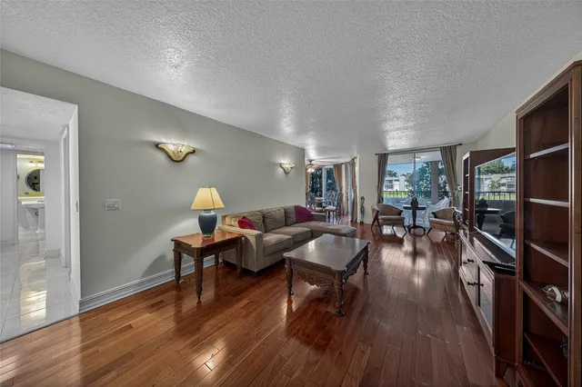 a living room with furniture and a wooden floor