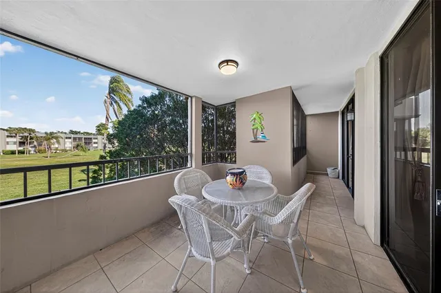 a dining room with furniture and a floor to ceiling window