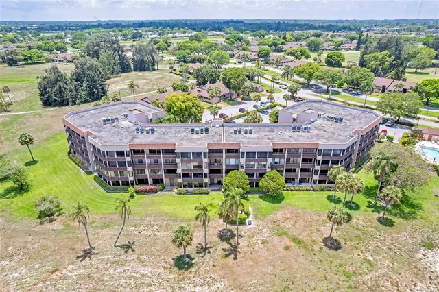 a front view of a house with a yard and potted plants