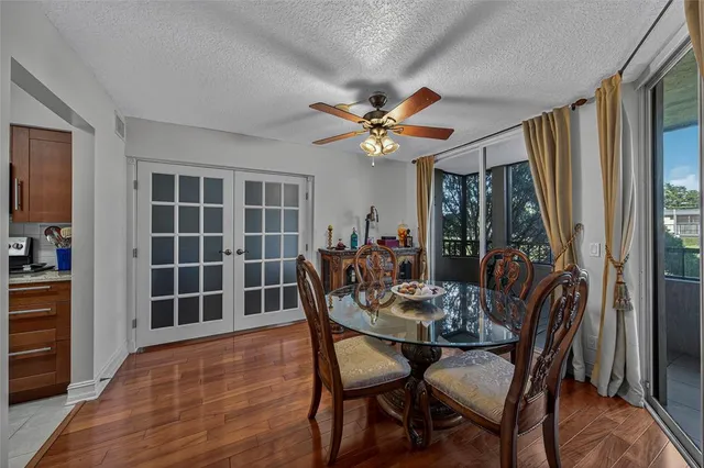 a view of a dining room with furniture and a window