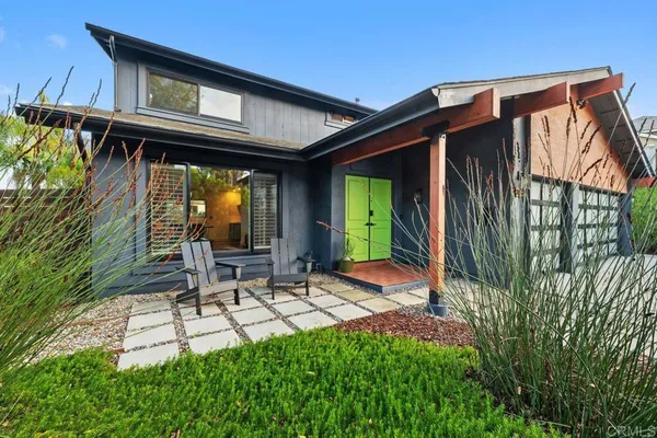 a view of an house with backyard and outdoor seating