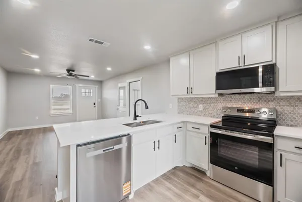 a kitchen with a sink stove and microwave