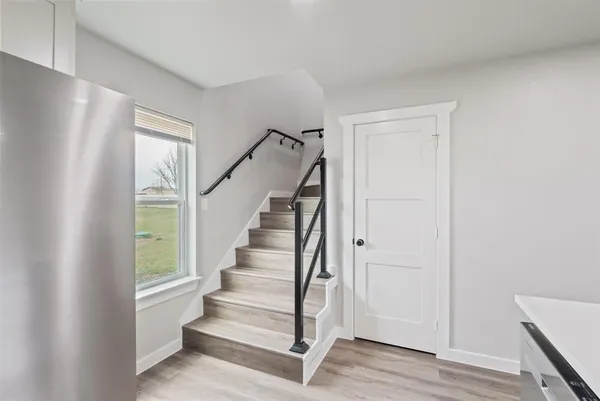 a view of entryway with wooden floor and stairs