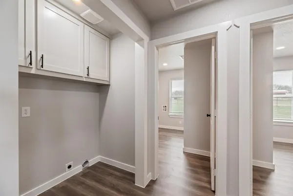 a view of empty room with wooden floor
