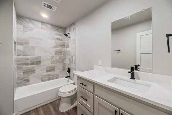 an empty room with a window and a ceiling fan