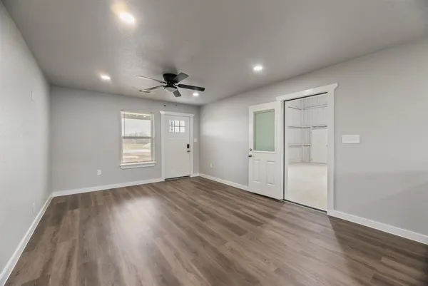 wooden floor in an empty room with a window