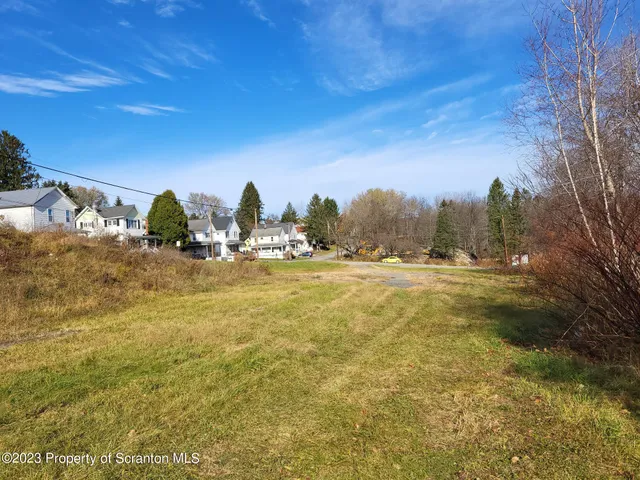 a view of yard with swimming pool and trees