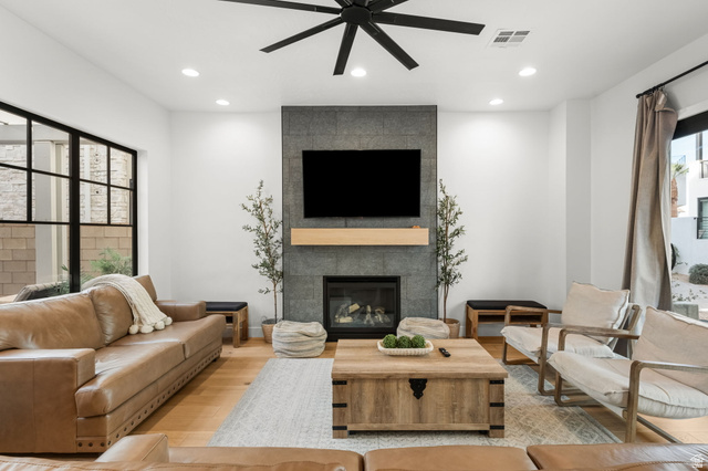 5354 Cyan Lane St. George, UT 84790 - Photo 7 of 45 Living room with a ceiling fan, wood finished floors, a tile fireplace, and recessed lighting