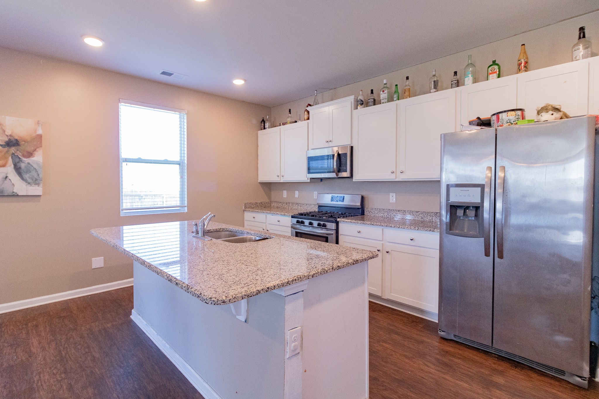 753 Prominence Road Columbia, TN 38401 - Photo 18 of 37 a kitchen with kitchen island granite countertop a sink a counter top space and stainless steel appliances