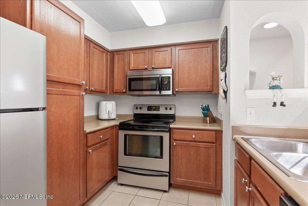 8550 Touchton Road, Unit 1437 Jacksonville, FL 32216 - Photo 12 of 36 a kitchen with a stove microwave and refrigerator