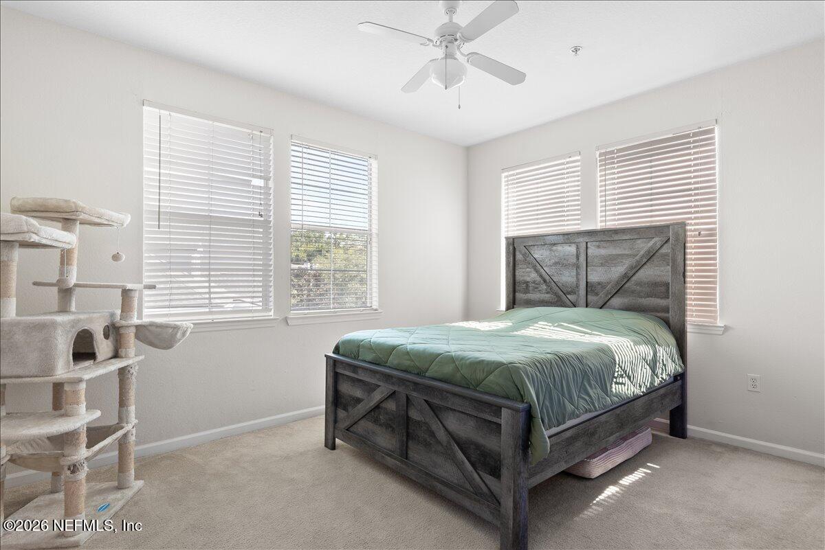 8550 Touchton Road, Unit 1437 Jacksonville, FL 32216 - Photo 18 of 36 a bed sitting in a bedroom next to a window