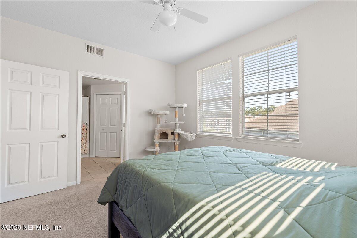 8550 Touchton Road, Unit 1437 Jacksonville, FL 32216 - Photo 19 of 36 a bedroom with a large bed and a window