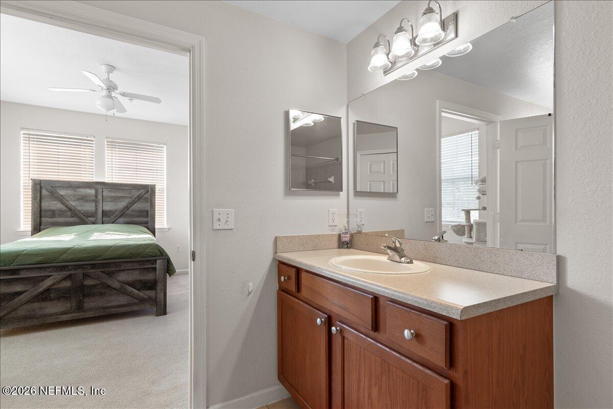 8550 Touchton Road, Unit 1437 Jacksonville, FL 32216 - Photo 21 of 36 a bathroom with a sink double vanity and a mirror