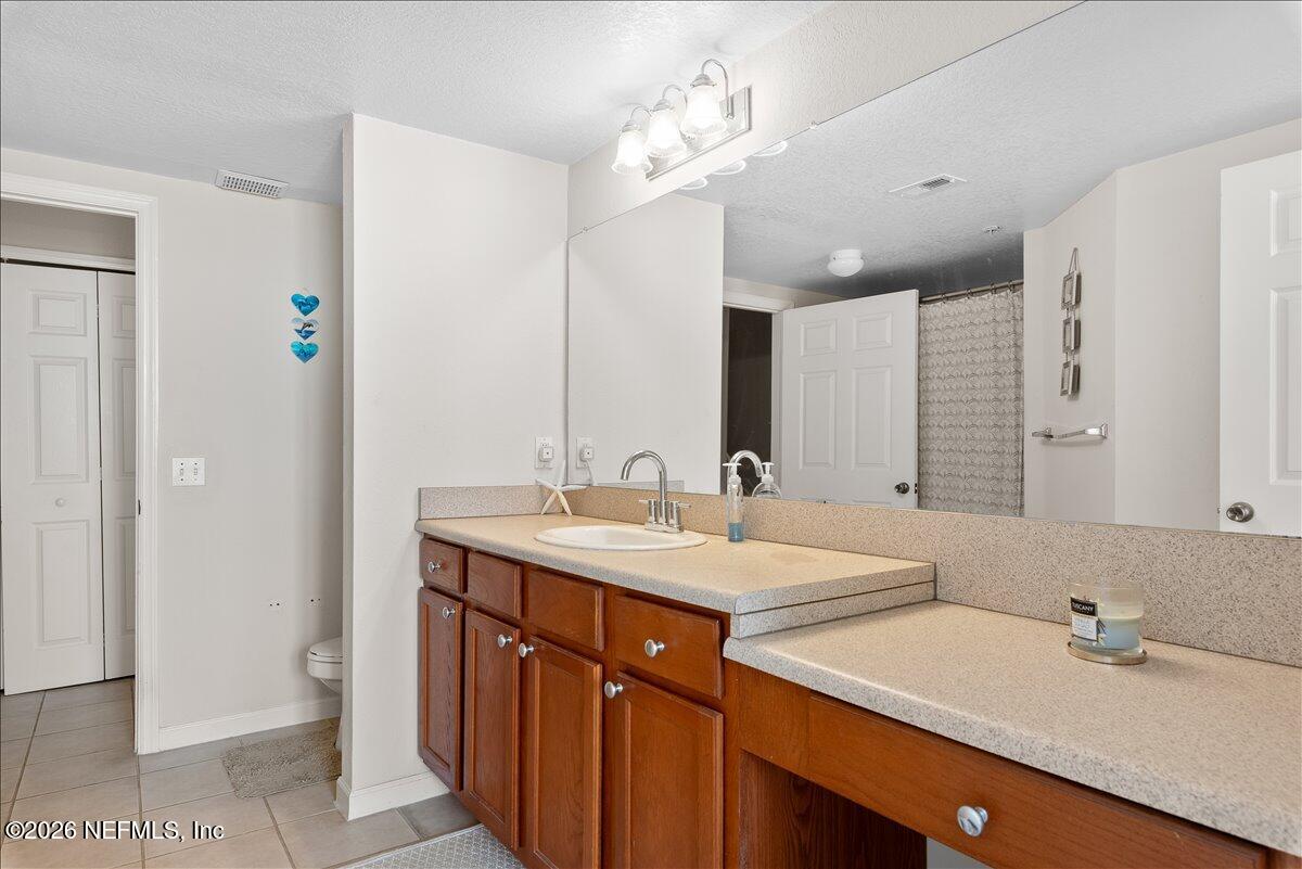 8550 Touchton Road, Unit 1437 Jacksonville, FL 32216 - Photo 26 of 36 a bathroom with a sink double vanity and a mirror