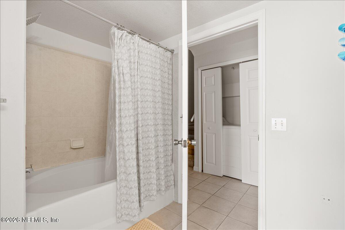8550 Touchton Road, Unit 1437 Jacksonville, FL 32216 - Photo 28 of 36 a bathroom with a bathtub and shower