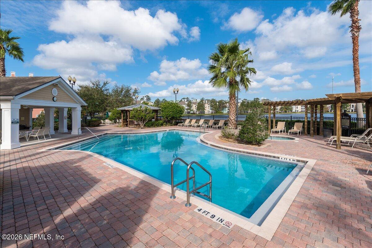 8550 Touchton Road, Unit 1437 Jacksonville, FL 32216 - Photo 36 of 36 a view of a house with swimming pool and sitting area