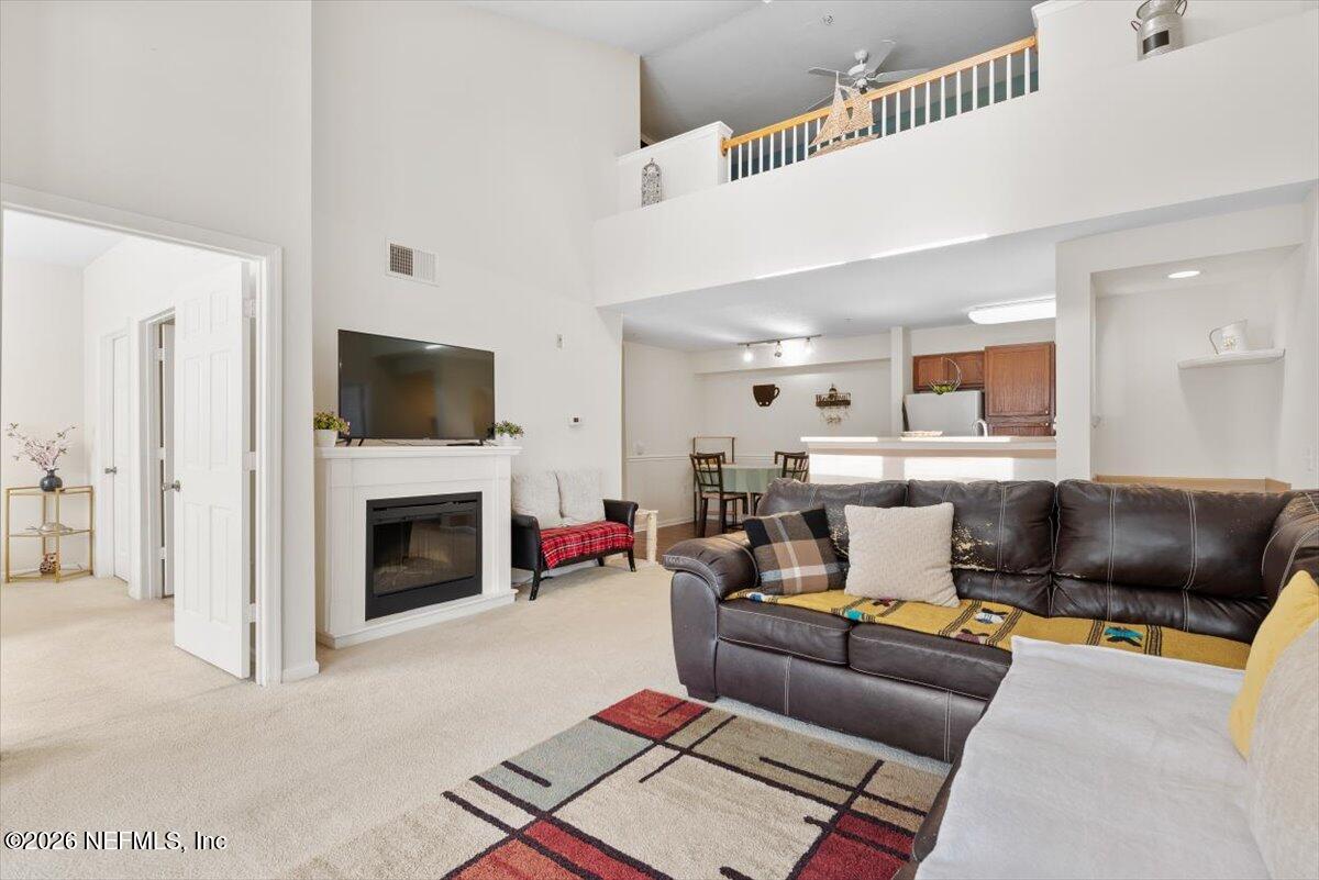 8550 Touchton Road, Unit 1437 Jacksonville, FL 32216 - Photo 4 of 36 a living room with furniture and a fireplace