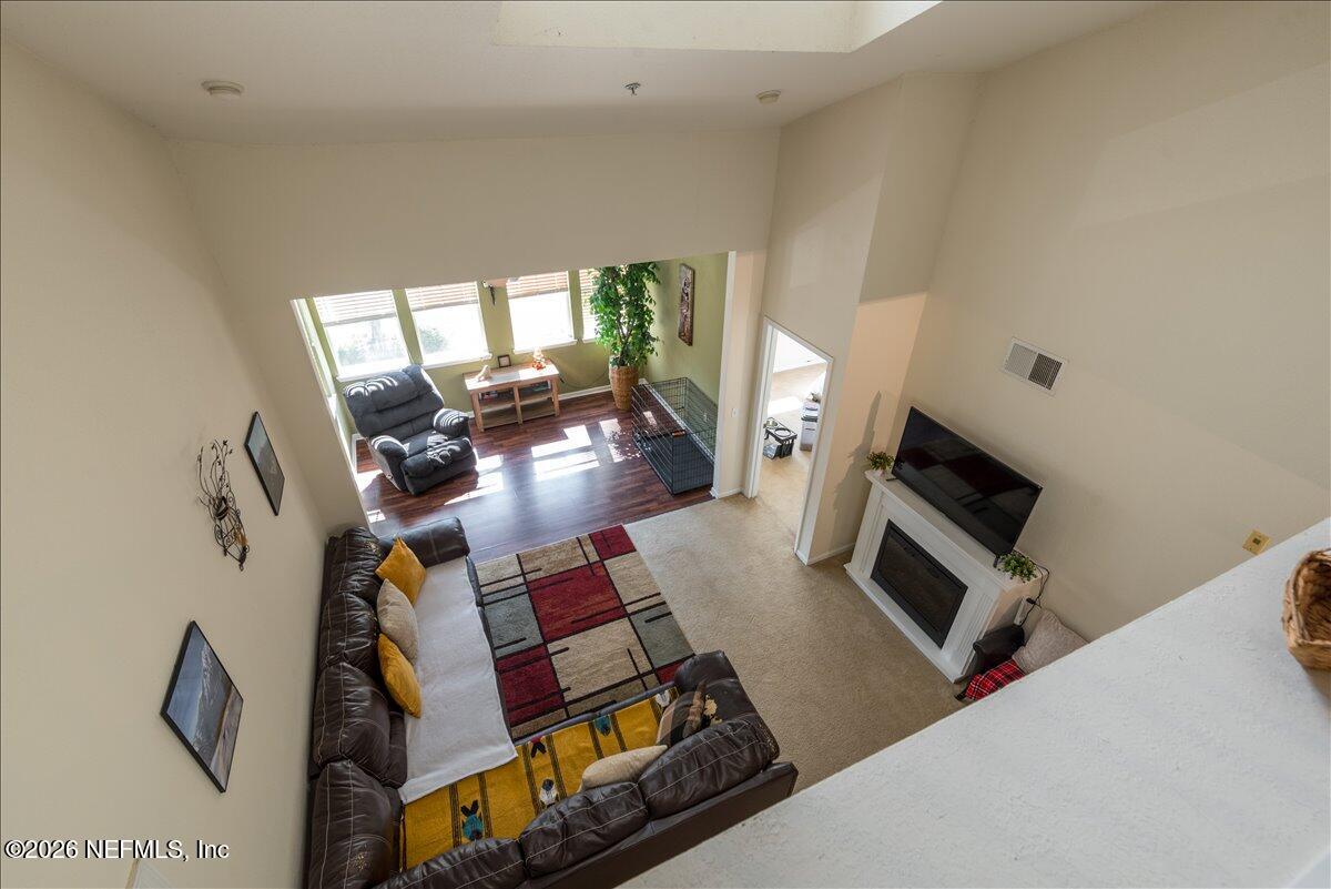 8550 Touchton Road, Unit 1437 Jacksonville, FL 32216 - Photo 5 of 36 a living room with furniture and a flat screen tv