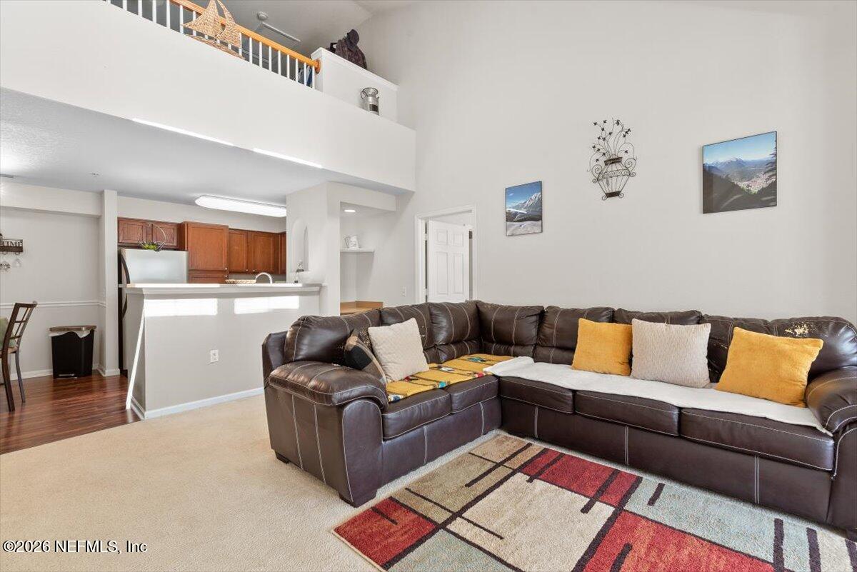 8550 Touchton Road, Unit 1437 Jacksonville, FL 32216 - Photo 6 of 36 a living room with furniture and a flat screen tv