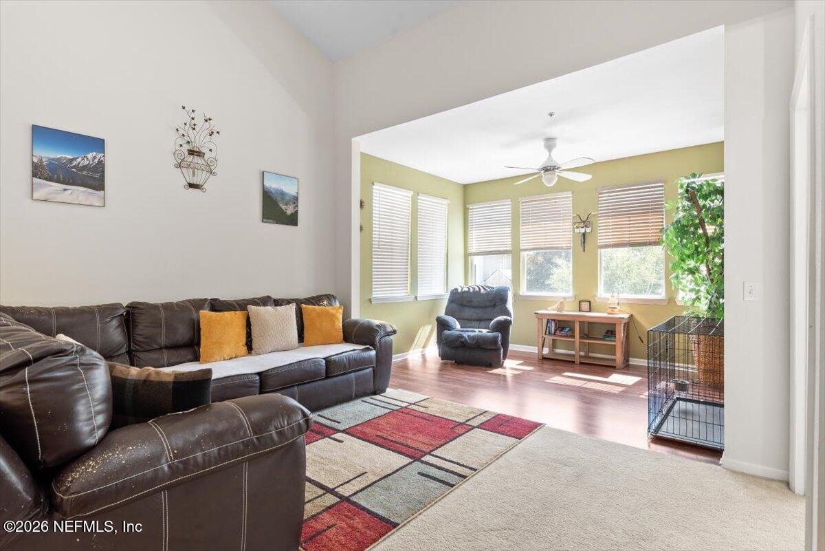 8550 Touchton Road, Unit 1437 Jacksonville, FL 32216 - Photo 7 of 36 a living room with furniture large windows and a table