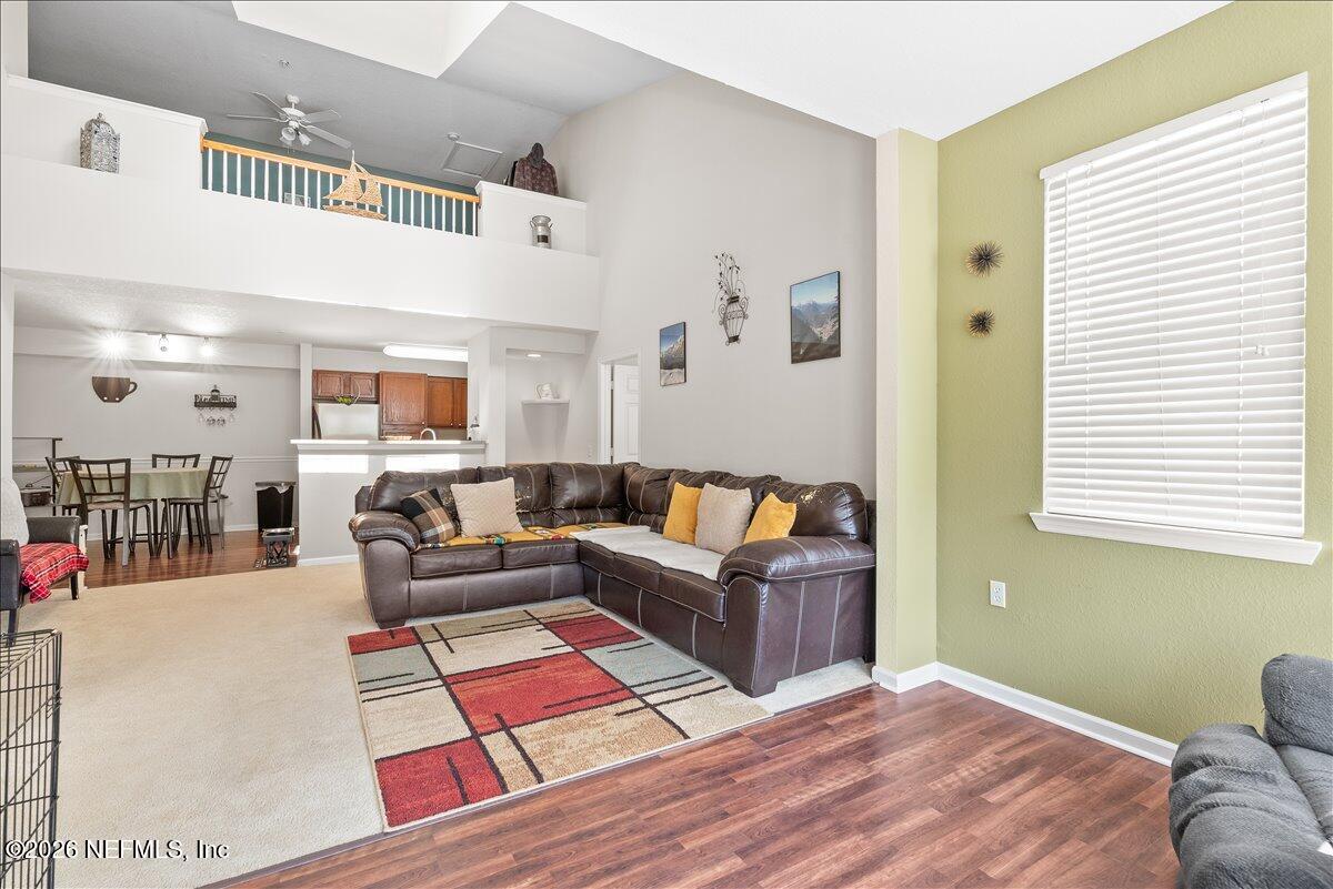 8550 Touchton Road, Unit 1437 Jacksonville, FL 32216 - Photo 10 of 36 a living room with furniture and a rug