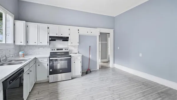 a kitchen with stainless steel appliances a stove a sink and a refrigerator