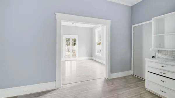 an empty room with cabinet and wooden floor