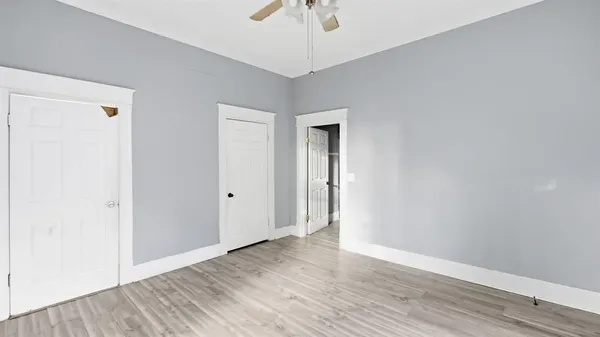 a view of an empty room with wooden floor