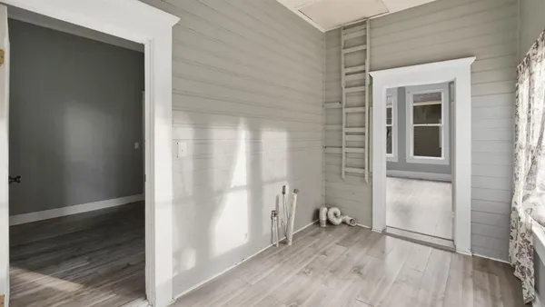 an empty room with wooden floor and a window
