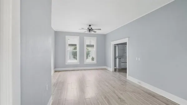 wooden floor in an empty room with a window