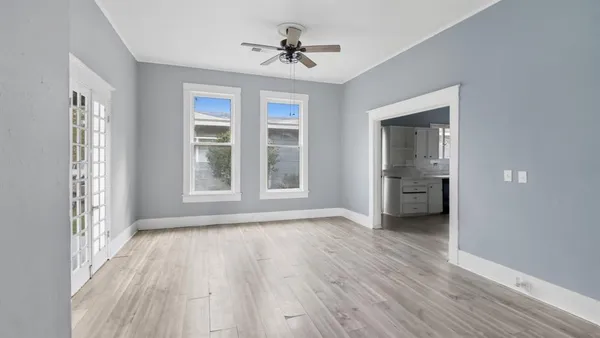 wooden floor in an empty room with a window