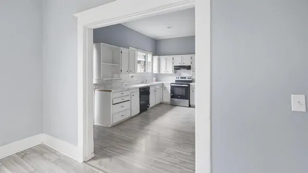 a kitchen with cabinets and stainless steel appliances