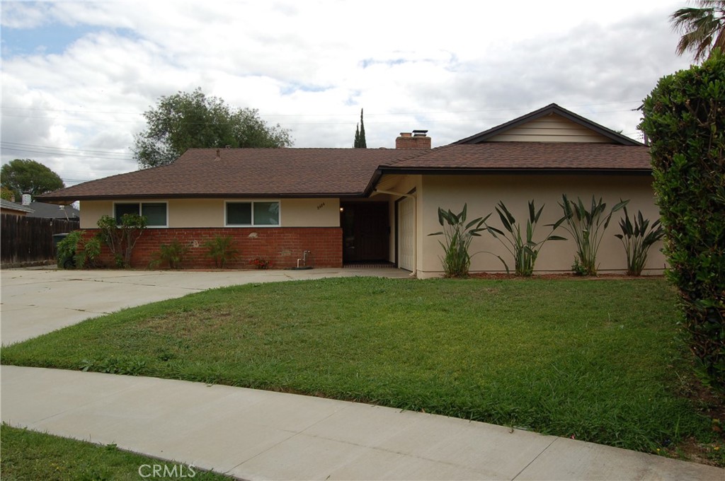 8484 Monteel Place Riverside, CA 92504 - Photo 1 of 34 a front view of a house with garden
