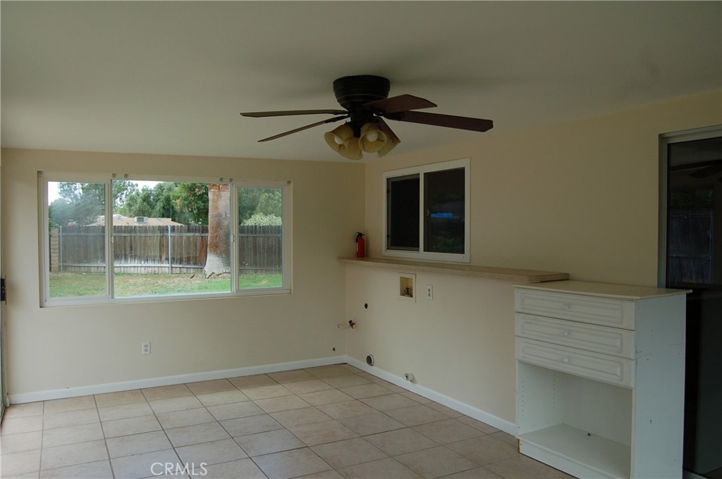 8484 Monteel Place Riverside, CA 92504 - Photo 14 of 34 a living room with a fireplace furniture a ceiling fan and a window