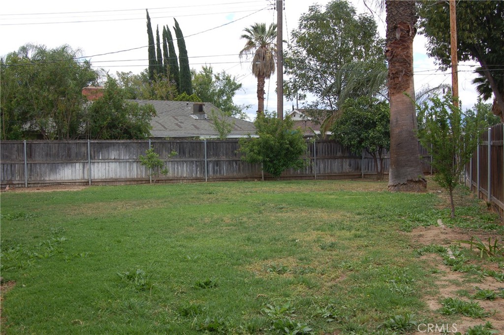 8484 Monteel Place Riverside, CA 92504 - Photo 15 of 34 a view of a backyard with a cabin and wooden fence