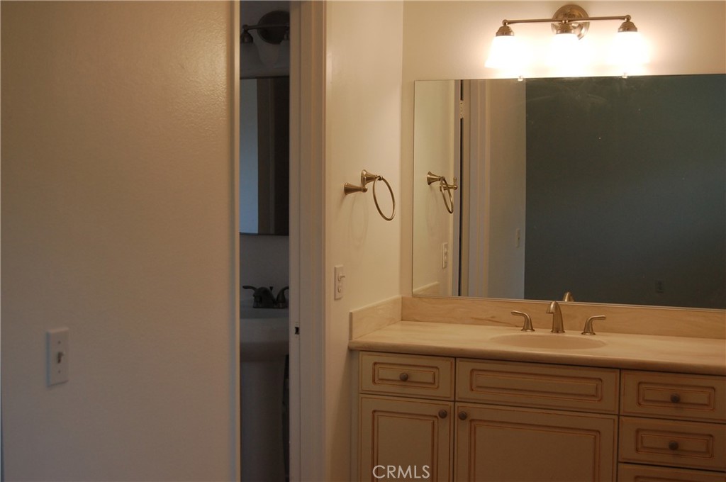 8484 Monteel Place Riverside, CA 92504 - Photo 17 of 34 a bathroom with a sink and mirror