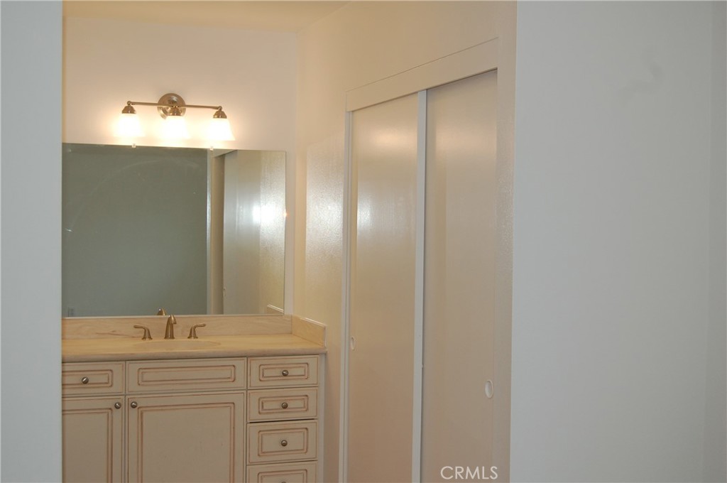 8484 Monteel Place Riverside, CA 92504 - Photo 19 of 34 a bathroom with a double vanity and mirror