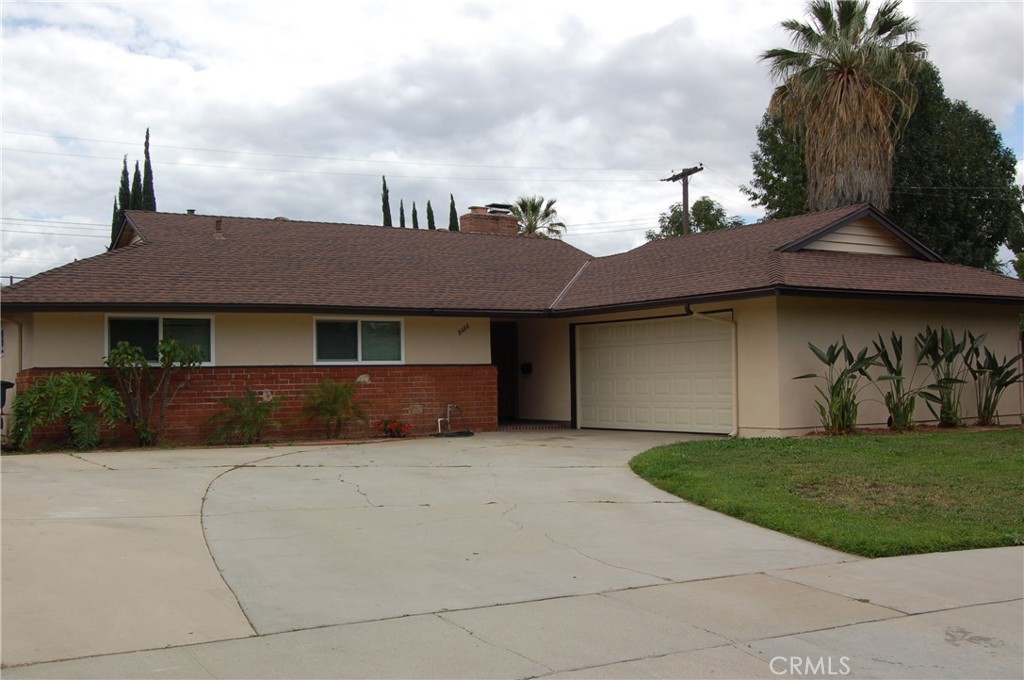 8484 Monteel Place Riverside, CA 92504 - Photo 2 of 34 a front view of a house with a garden and yard