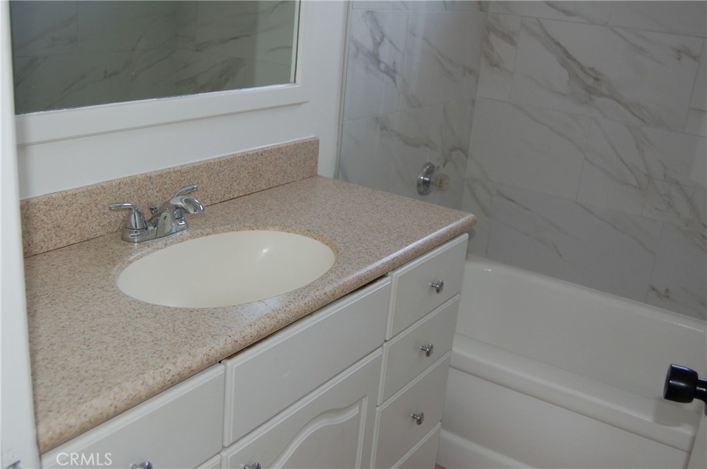 8484 Monteel Place Riverside, CA 92504 - Photo 22 of 34 a bathroom with a granite countertop sink and a mirror