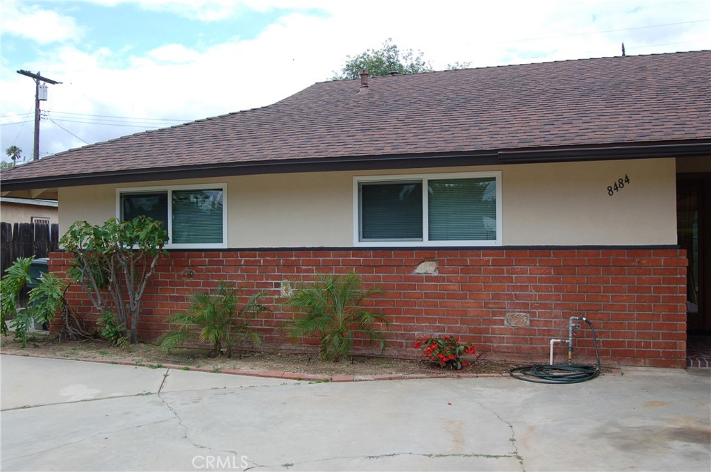 8484 Monteel Place Riverside, CA 92504 - Photo 4 of 34 a front view of a house with a garden