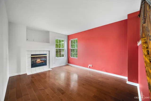 a view of an empty room with a fireplace and a window