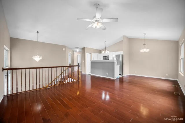 a view of a room with wooden floor fan and window