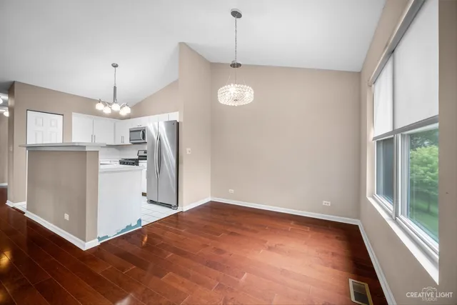 a view of a kitchen with a sink refrigerator and window
