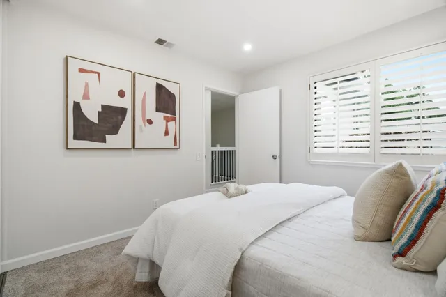 a bedroom with a large bed and a window